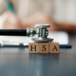 HSA Health Savings Account Wooden Blocks Near Stethoscope On Table