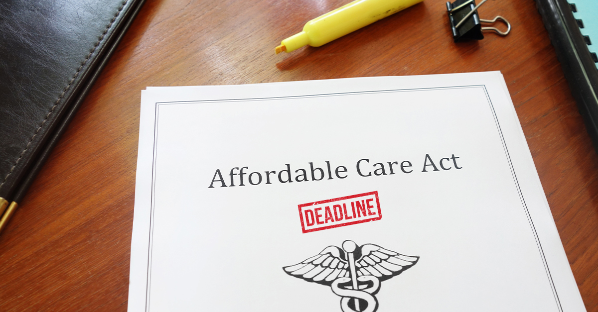 Affordable Care Act (ACA) document on an office desk with a red deadline stamp