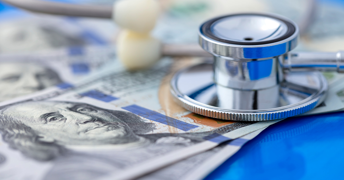 Closeup of a stethoscope on top of hundred dollar bills, illustrating the blog topic The Future of Health Insurance and Plan Options with the Trump Administration